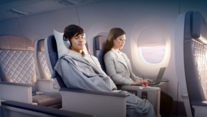 a man and woman sitting in an airplane