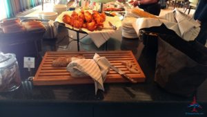 a cutting board with a knife and a plate of chicken