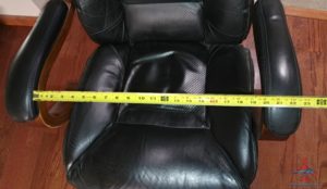 a black chair with a yellow tape measure