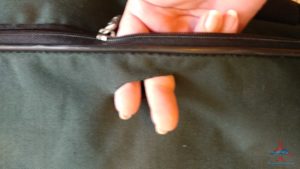 a person's hand sticking out of a zipper