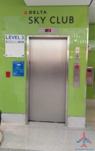 an elevator with a green wall
