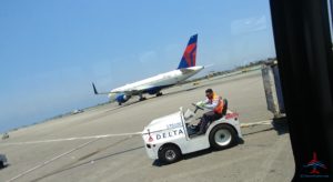a man in a small vehicle on a runway