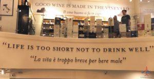 a sign with a shelf of wine