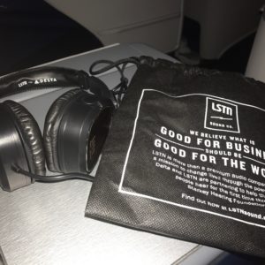 a black headphones next to a black bag