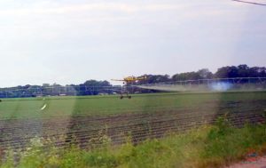 a field with a plane spraying it