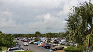 a parking lot with cars and palm trees
