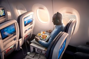a man eating food in an airplane