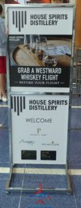 a sign with a drink and a glass of whiskey