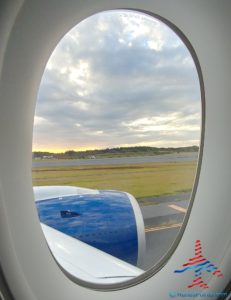 an airplane window with a view of the wing