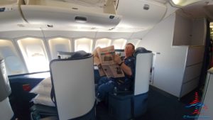 a man reading a newspaper on an airplane