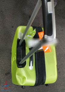a green suitcase with a handle