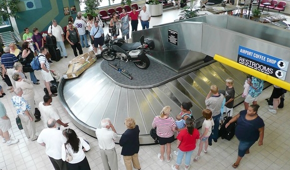 Passengers waiting at a luggage carousel