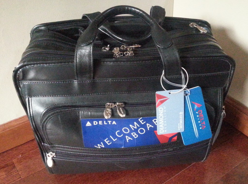 a black leather suitcase with a tag on it