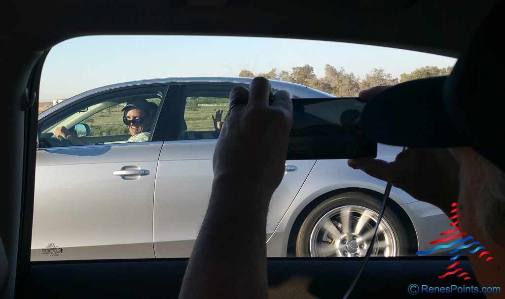a person taking a picture of a woman in a car