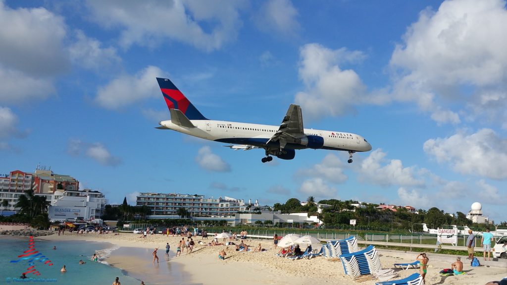 a plane flying over a beach