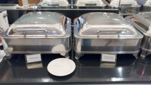 a group of silver containers on a black counter