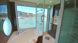 a bathroom with a bathtub and a view of water