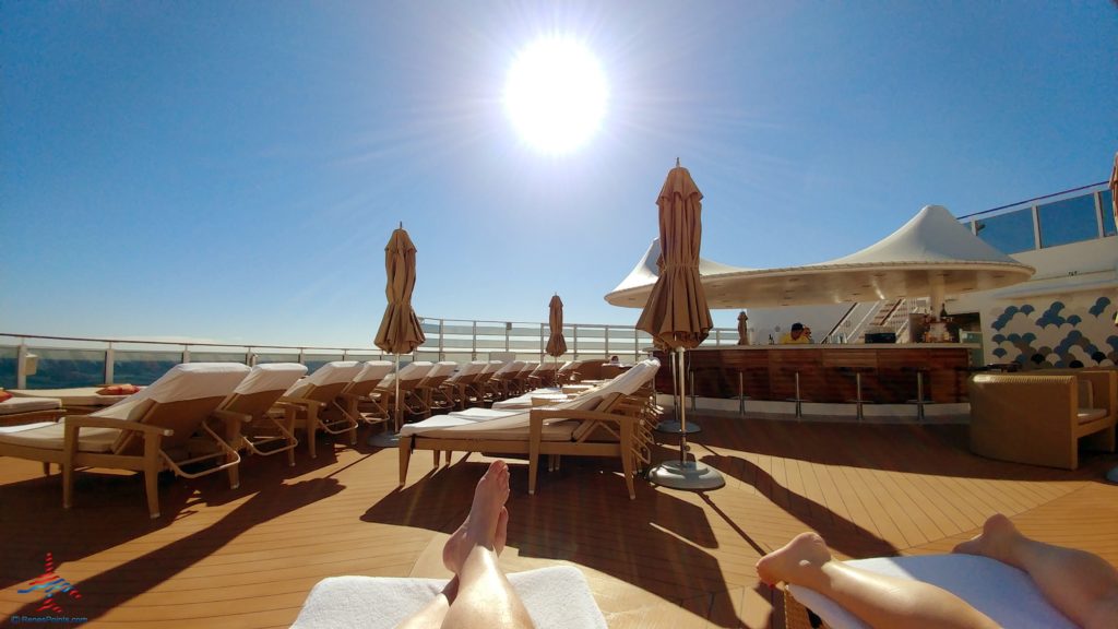 a person's feet on a deck of a cruise ship