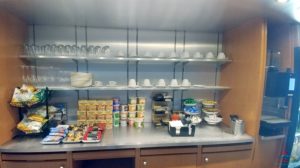 a kitchen with shelves and cups