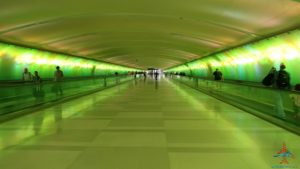 a long green tunnel with people walking