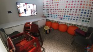 a room with orange chairs and a television
