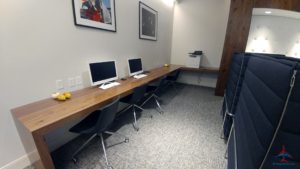 a room with computers on a long table