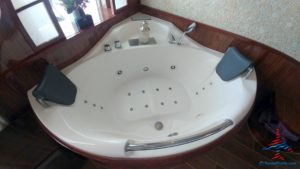 a white bathtub with a wood frame