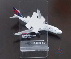 a puzzle piece in a plastic holder with a plane model