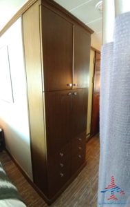 a tall wooden cabinet in a room