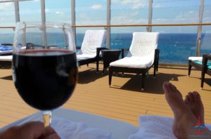 a glass of wine on a deck