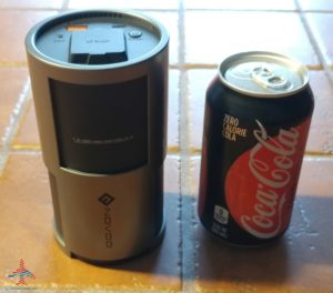 a can of soda next to a device