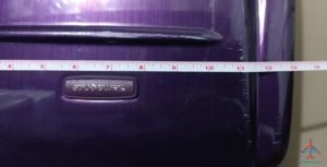 a tape measure on a purple suitcase