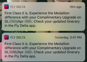 Fly Delta notifications alerting a passenger to first class upgrades, as seen on an iPhone home screen.
