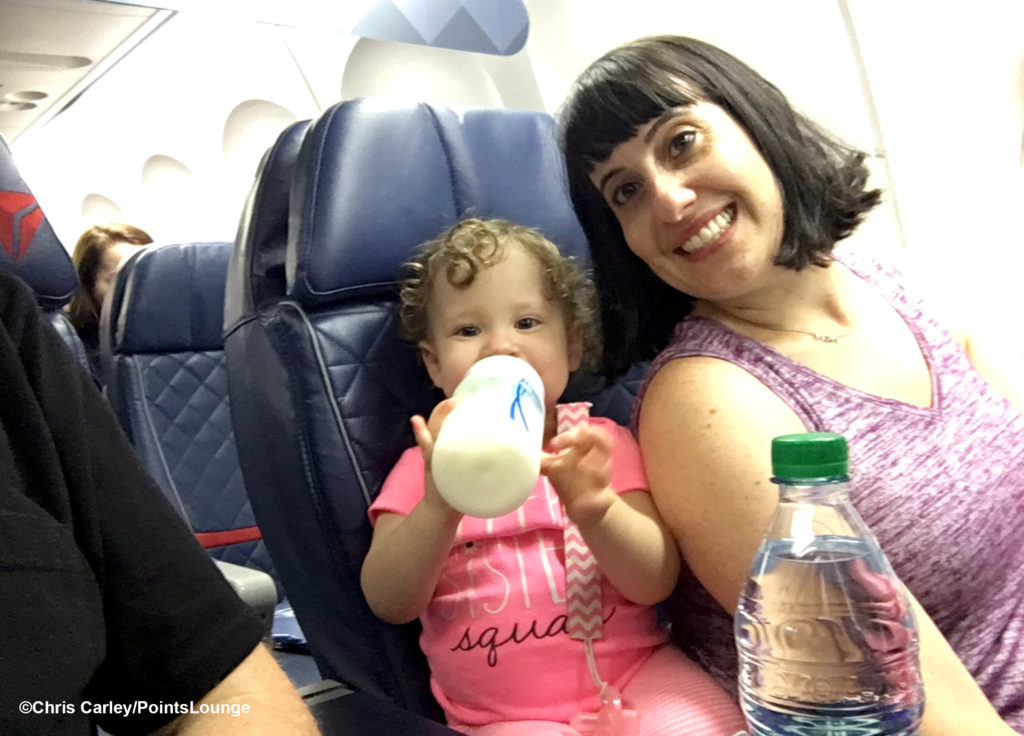 Mother and daughter sitting in first class on a Delta Air Lines flight