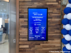 A sign with opening and closing hours, plus admission policy, is seen outside the Delta Sky Club Austin airport lounge at Austin-Bergstrom International Airport (AUS) in Austin, Texas. Photo © Chris Carley / PointsLounge