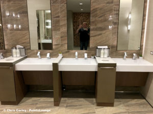 Sinks and mirrors are photographed by Chris Carley at the Delta Sky Club Austin airport lounge at Austin-Bergstrom International Airport (AUS) in Austin, Texas. Photo © Chris Carley / PointsLounge