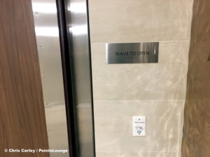 A wave-to-open motion activated door opening sensor is seen inside the men's restroom at the Delta Sky Club Austin airport lounge at Austin-Bergstrom International Airport (AUS) in Austin, Texas. Photo © Chris Carley / PointsLounge