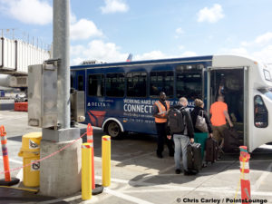 Passengers board a Delta shuttle bus at Terminal 2 at Los Angeles International Airport in Westchester, CA. © Chris Carley / PointsLounge