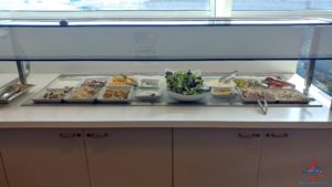a buffet table with food in containers