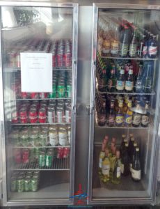 a refrigerator with bottles of drinks