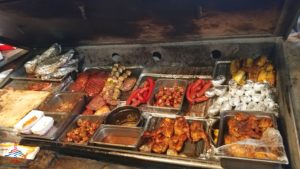 a trays of food on a grill