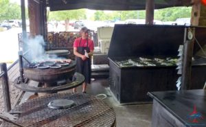 a person standing in front of a large grill