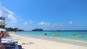 a beach with a cruise ship in the background