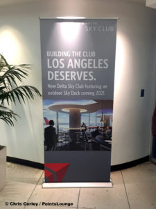 A banner outside the main Delta Sky Club at LAX Terminal 3 announces a new Sky Club airport lounge with outdoor Sky Deck coming in 2021.