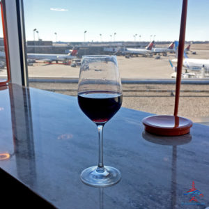 Enjoying planespotting and red wine at the MSP Escape Lounge!