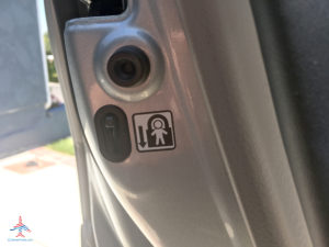 An unlocked child safety lock inside a Toyota Highlander.