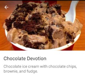 a bowl of chocolate ice cream with a spoon