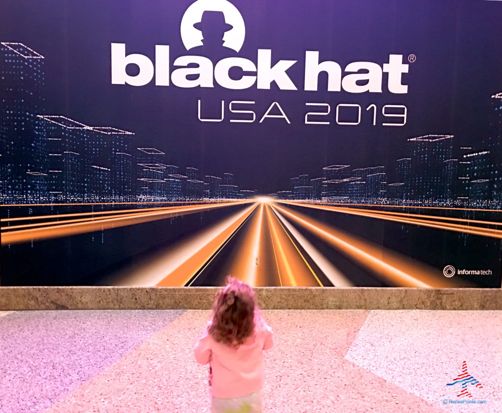 My daughter is entranced by Informatech's Black Hat USA 2019 mural at Mandalay Bay Convention Center in Paradise, Nevada, outside of Las Vegas.
