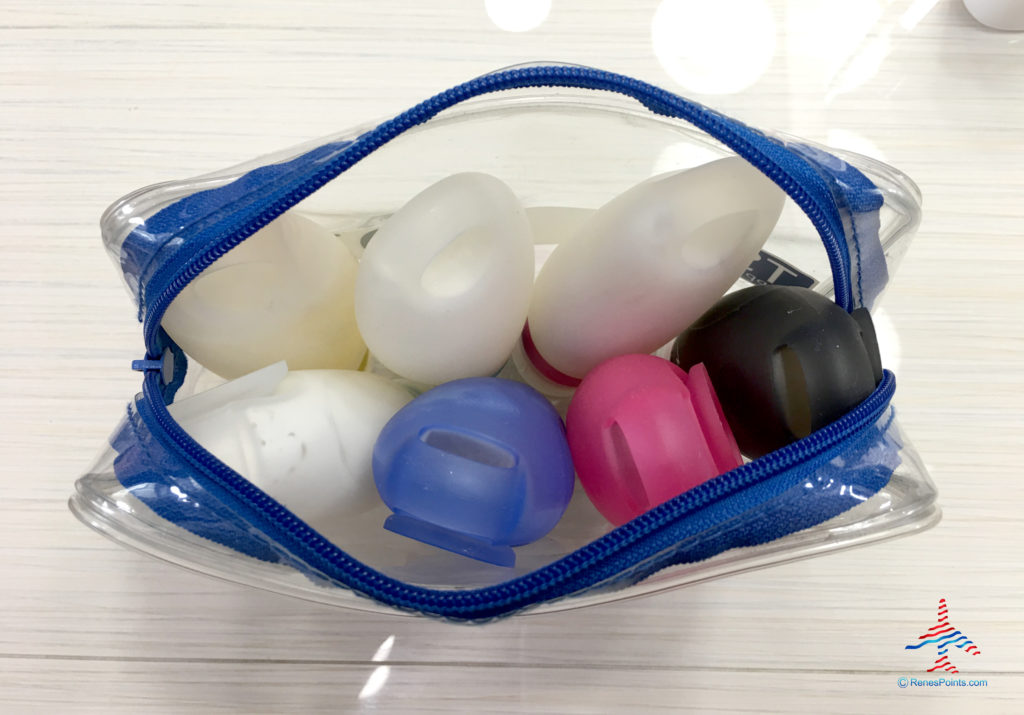 Leakproof, silicone, reusable toiletry tubes are seen in a Tozy clear toiletry bag.