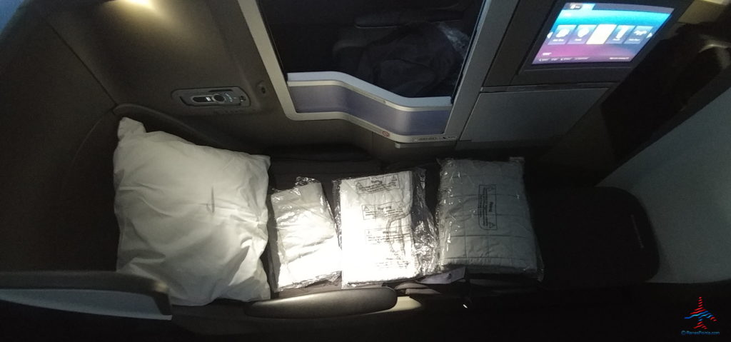 a group of white pillows on a seat
